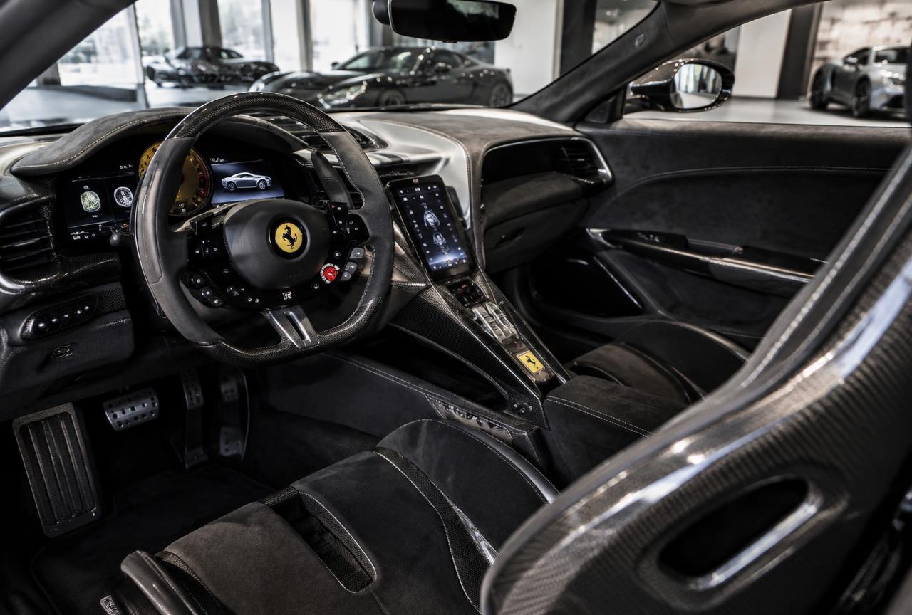 Modern supercar cockpit with black Alcantara and carbon fiber trim